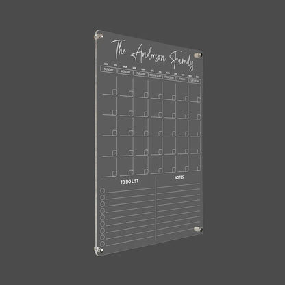 3D render of the personalized vertical family acrylic calendar with silver standoff hardware on a dark background