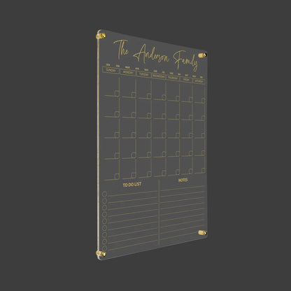 3D render of the personalized vertical family acrylic calendar with gold standoff hardware on a dark background