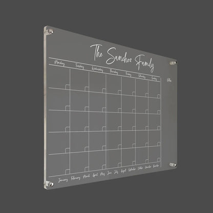 3D render of 'The Sanchez Family' acrylic monthly calendar with silver standoff hardware on a dark background