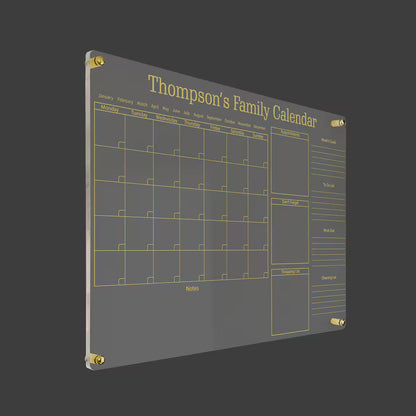 Angled close-up of 'Thompson's Family Calendar' acrylic planner with appointments and to-do sections