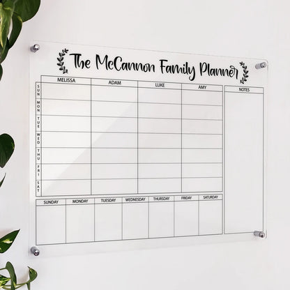 Personalized clear acrylic 'The McCannon Family Planner' with named columns and a weekly date grid