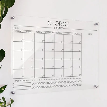 Personalized clear acrylic 'George Family' calendar with monthly grid and dual-row habit tracker