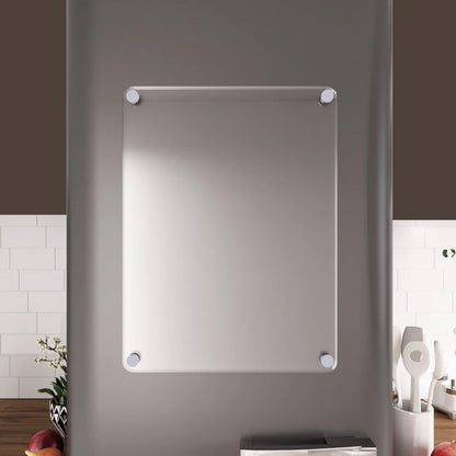 Blank clear acrylic dry-erase board with silver standoffs mounted on a kitchen wall above a counter