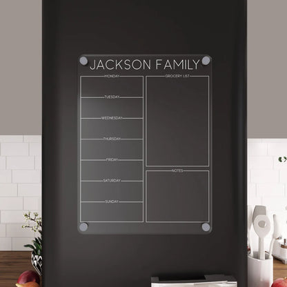 Personalized acrylic 'Jackson Family' magnetic fridge planner mounted on a matte black refrigerator