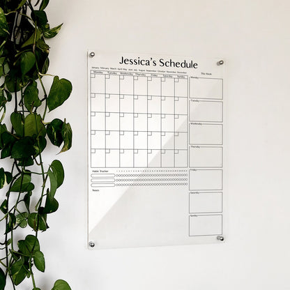 Personalized clear acrylic 'Jessica's Schedule' calendar with monthly grid, weekly boxes, and habit tracker