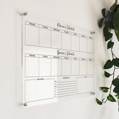 Personalized clear acrylic dual-schedule planner for 'Monica' and 'Darren' with reminders, meal planner, and notes