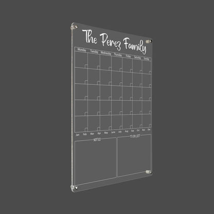3D render of the personalized family acrylic calendar with silver standoff hardware on a dark background