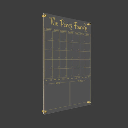 3D render of the personalized family acrylic calendar with gold standoff hardware on a dark background