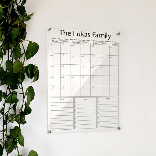 Personalized clear acrylic 'The Lukas Family' calendar with notes, weekly menu, and to-do columns
