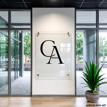 Large bold 'CA' monogram engraved on a clear acrylic panel, close frontal view